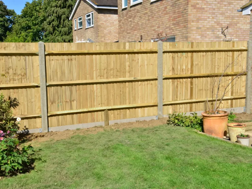 a fenced in yard with a wood fence and plants