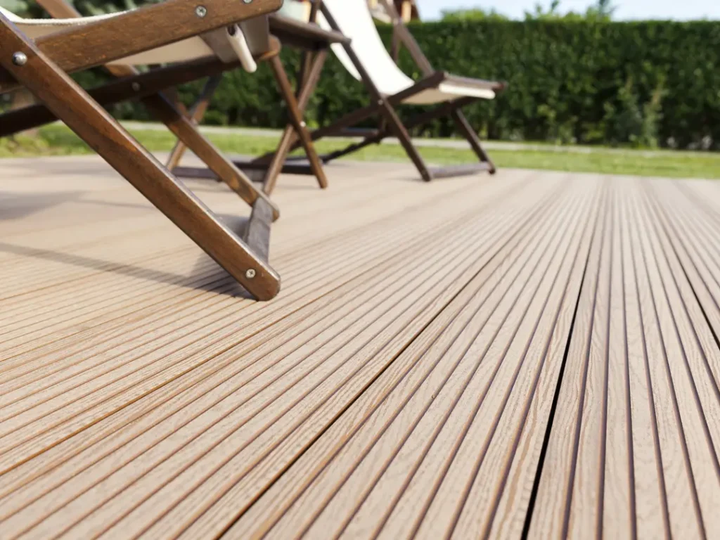 a wood deck with a chair and a table on it