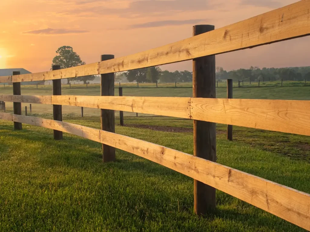 a wooden fence in a field