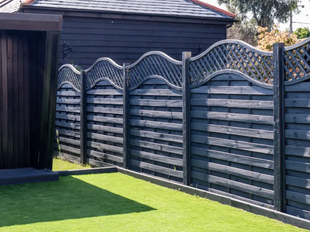 a wooden fence in front of a house