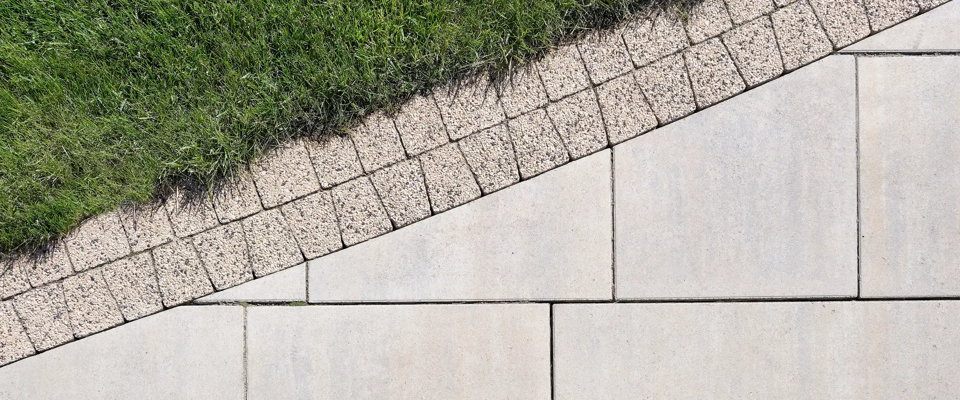 a paved area with grass